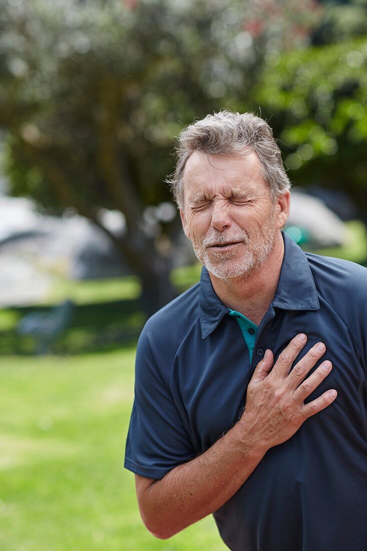 Senior man holding his chest in pain