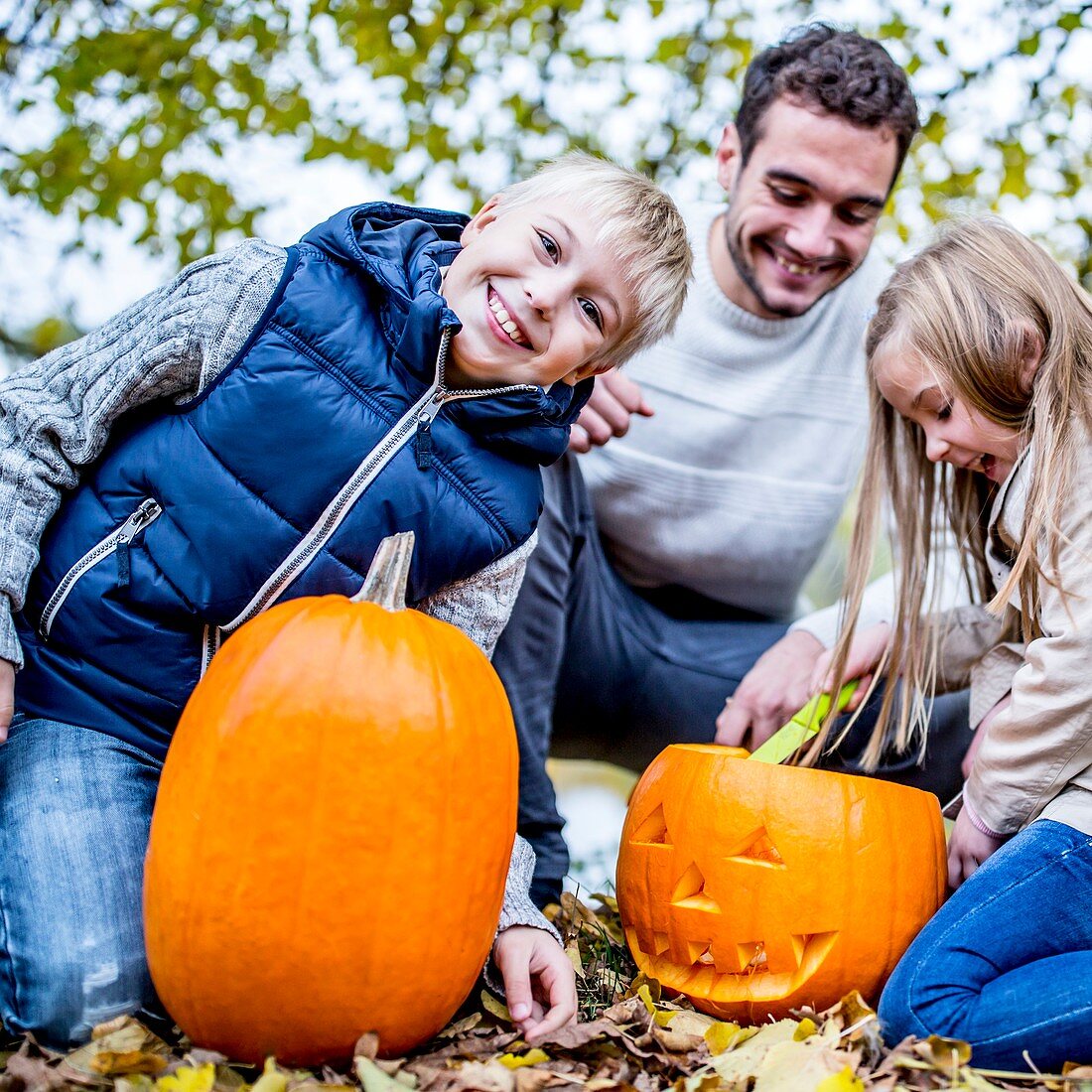 Family with Halloween pumpkin
