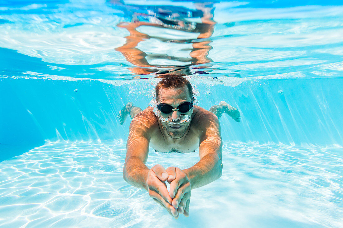 Man swimming in pool