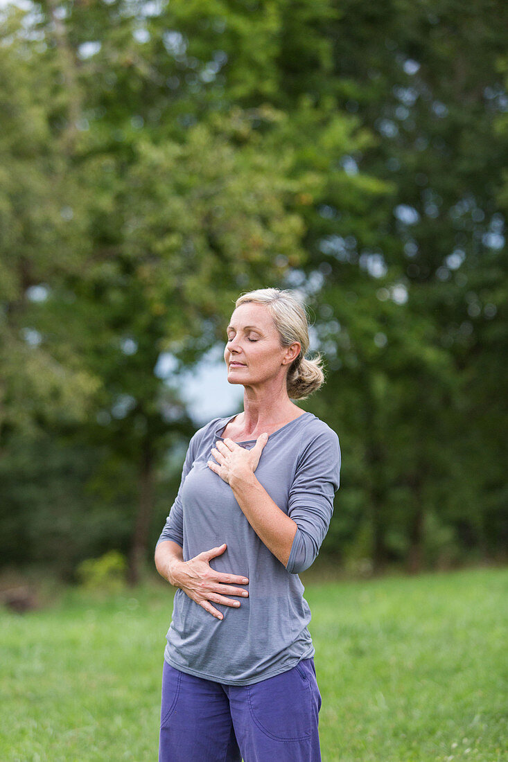 Senior woman practicing respiratory exercises