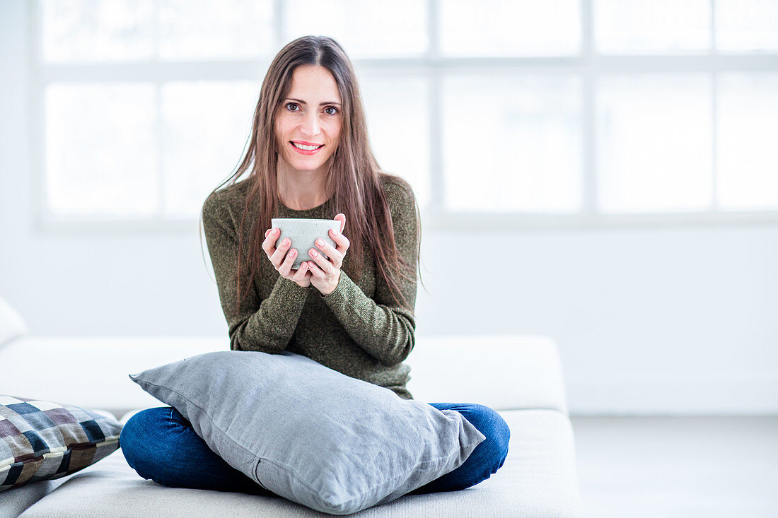 Woman drinking hot beverage