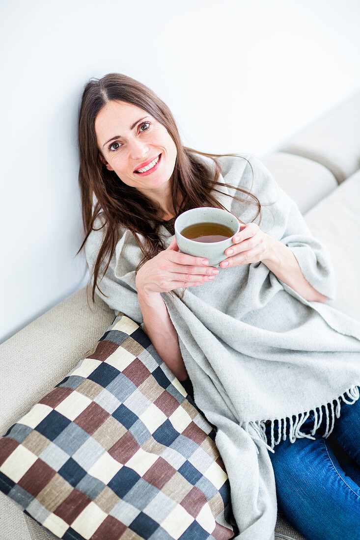 Woman drinking hot beverage