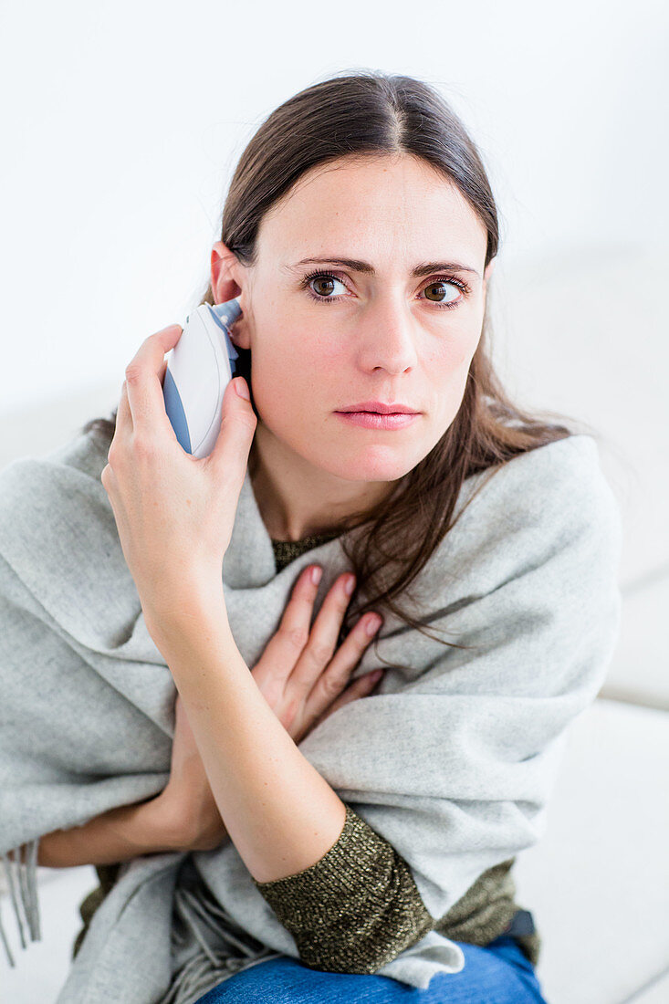 Woman taking her temperature