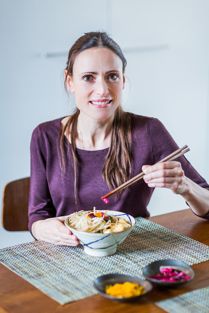 Woman eating a Japanese salad