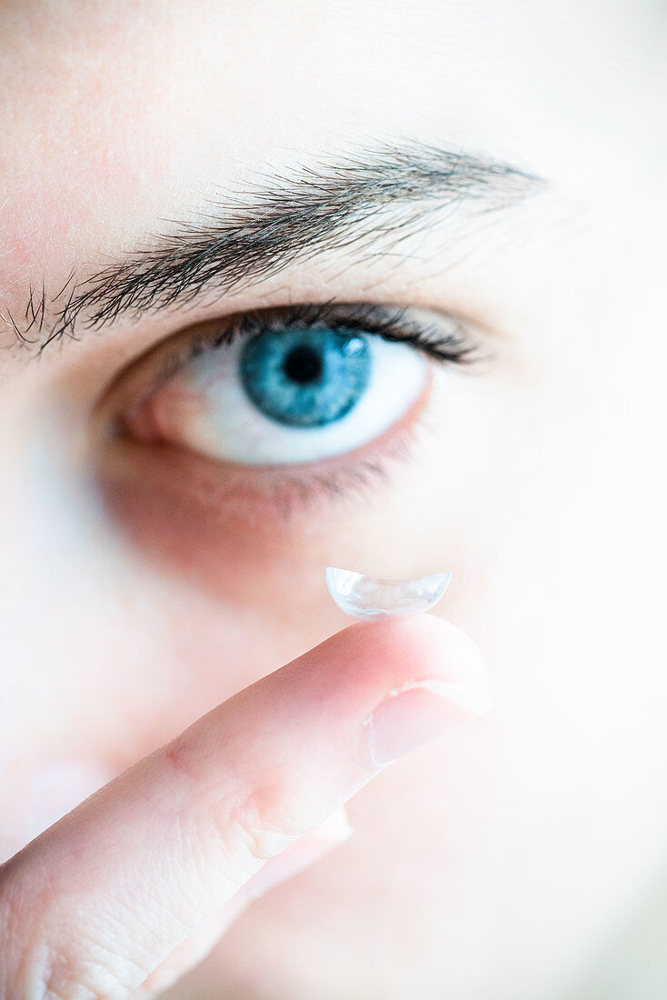Woman putting in a contact lens