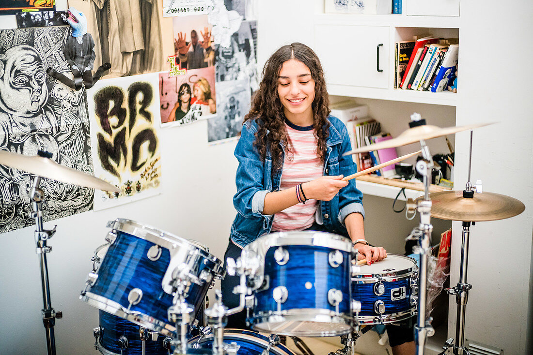 Teenage girl playing drums