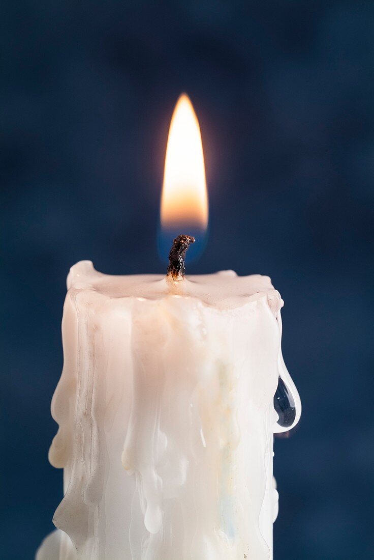 Lit candle with melted wax