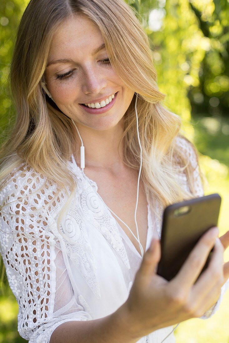 Woman listening to music on smartphone