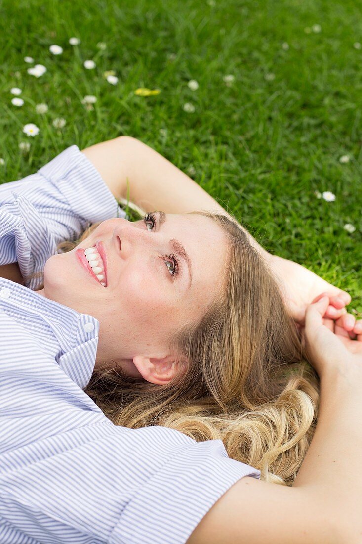 Woman lying on grass smiling