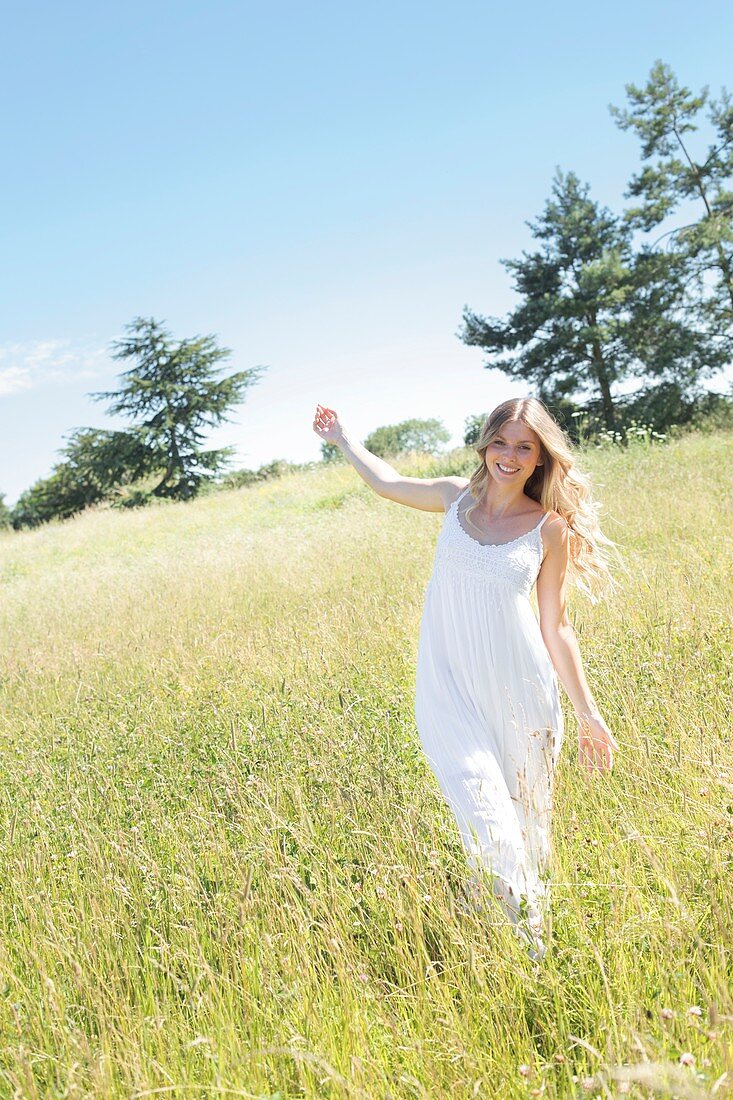 Woman walking in meadow