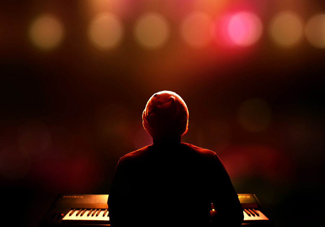 Person playing piano on stage