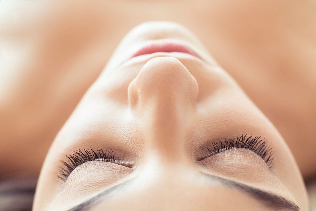 Woman lying on back with eyes closed