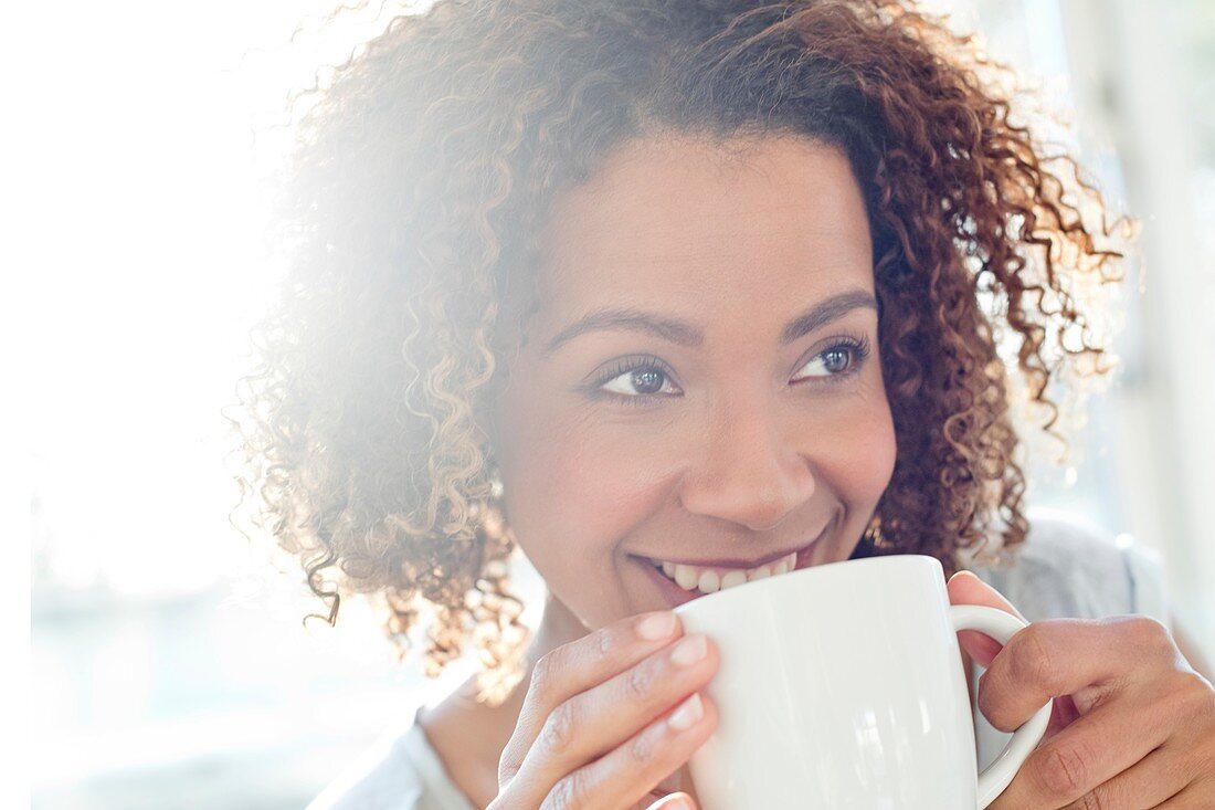 Mid adult woman drinking coffee