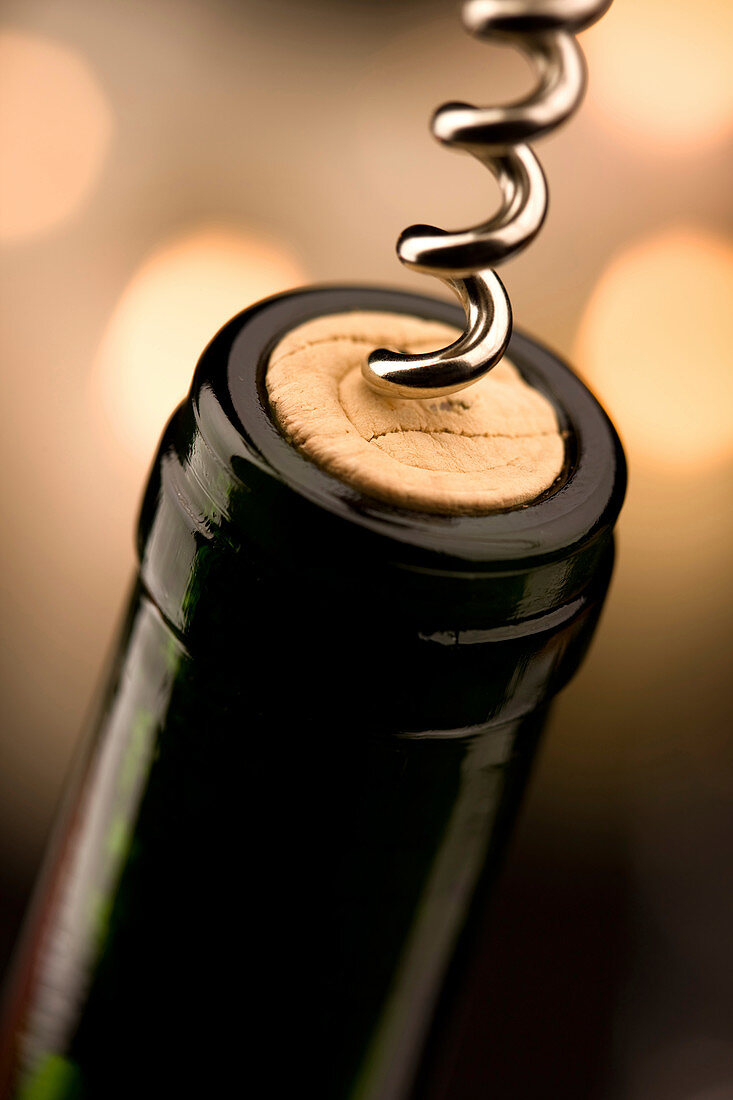 Wine bottle with corkscrew removing cork