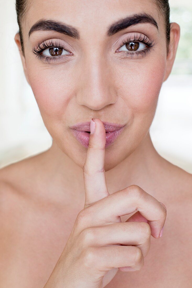 Woman with finger on lips