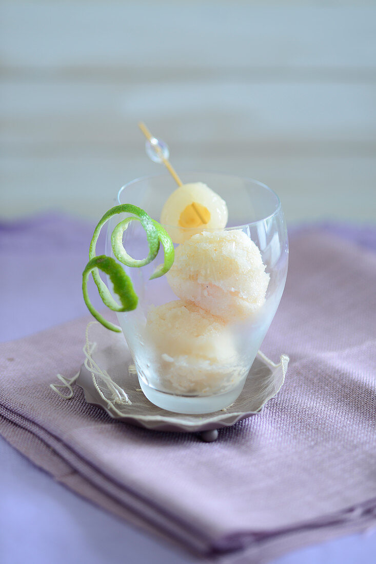 Lychee ice cream in a glass with lime peel