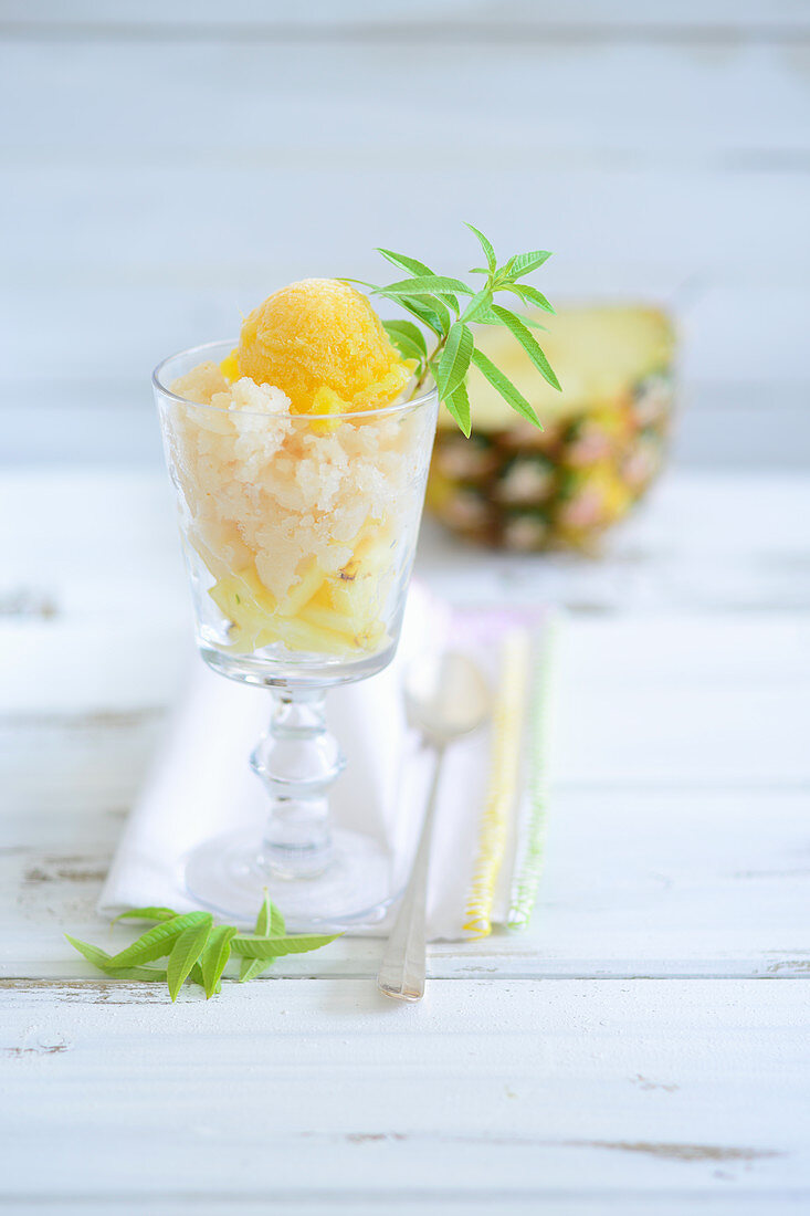 A pineapple ice cream sundae with a stemmed glass