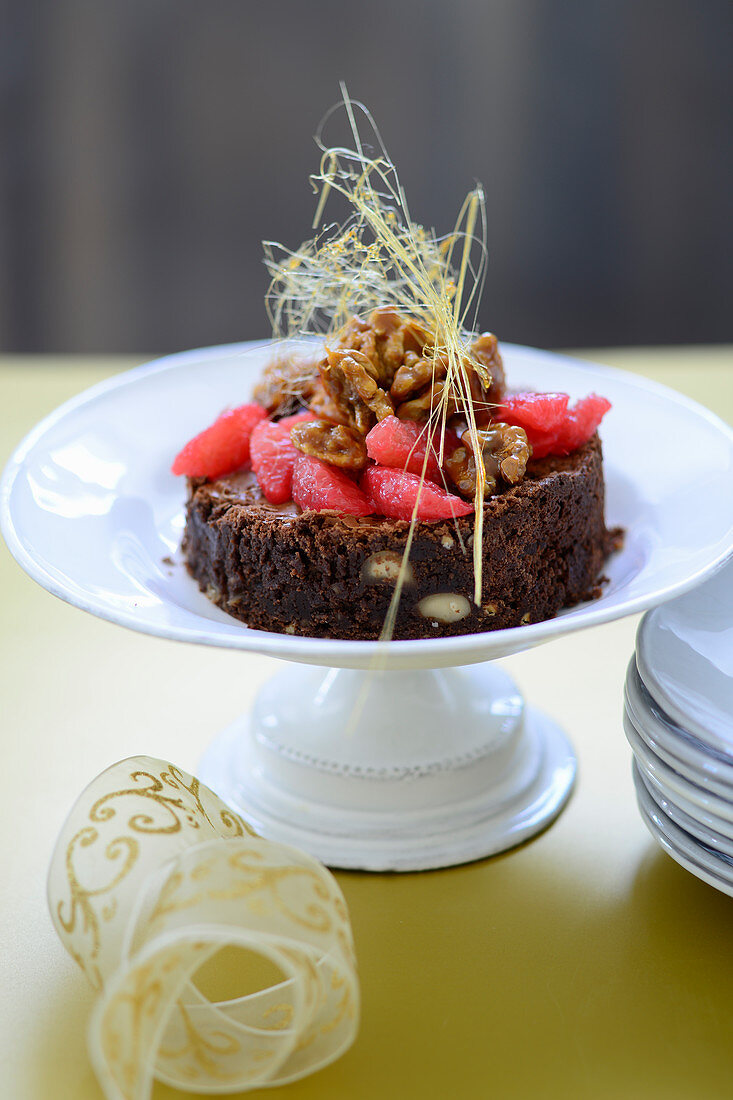 Chocolate cake with pink grapefruit and caramelised walnuts