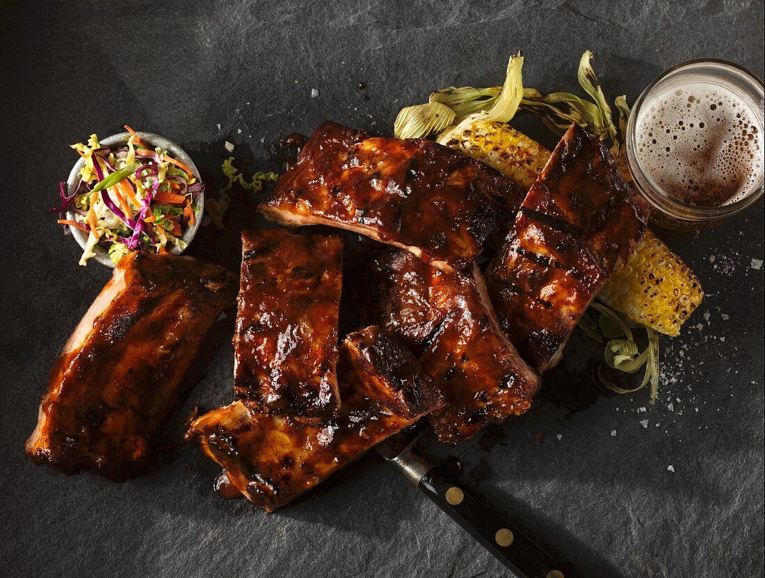 BBQ spare ribs with coleslaw, corn on the cob and beer