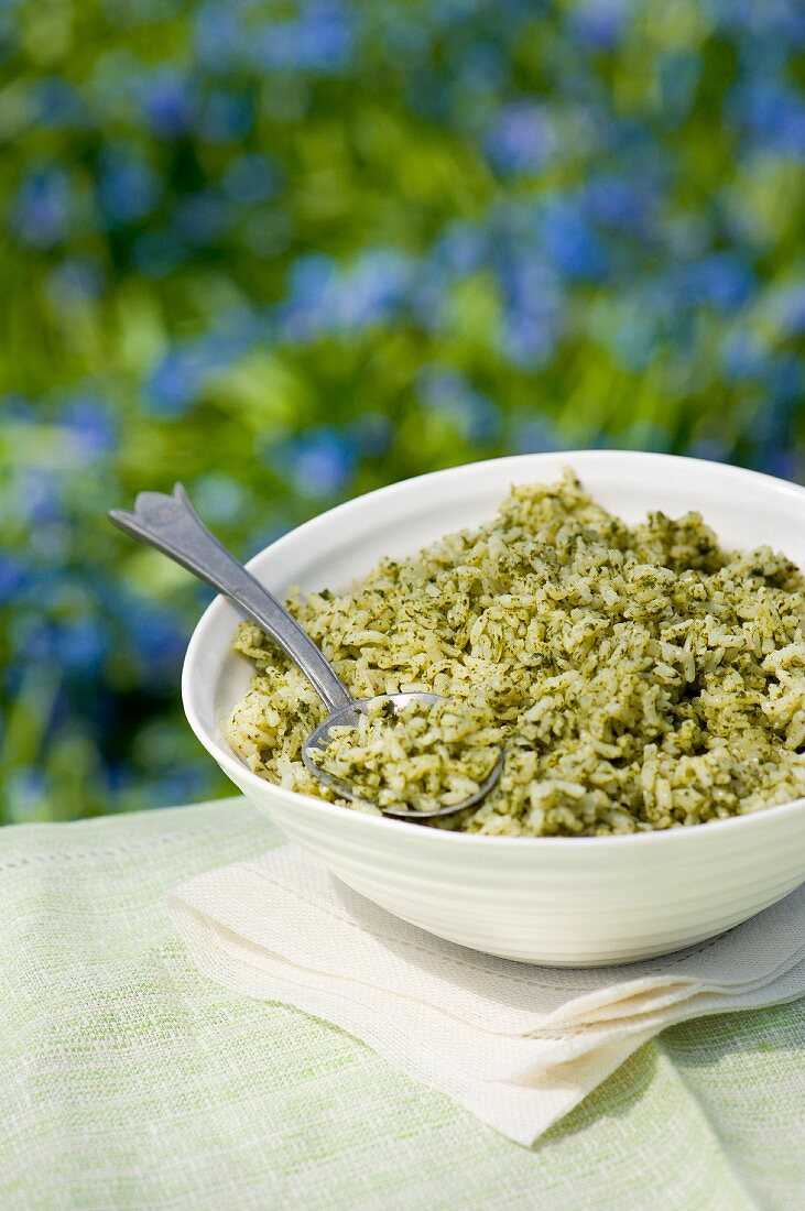 A bowl of rice with green pesto