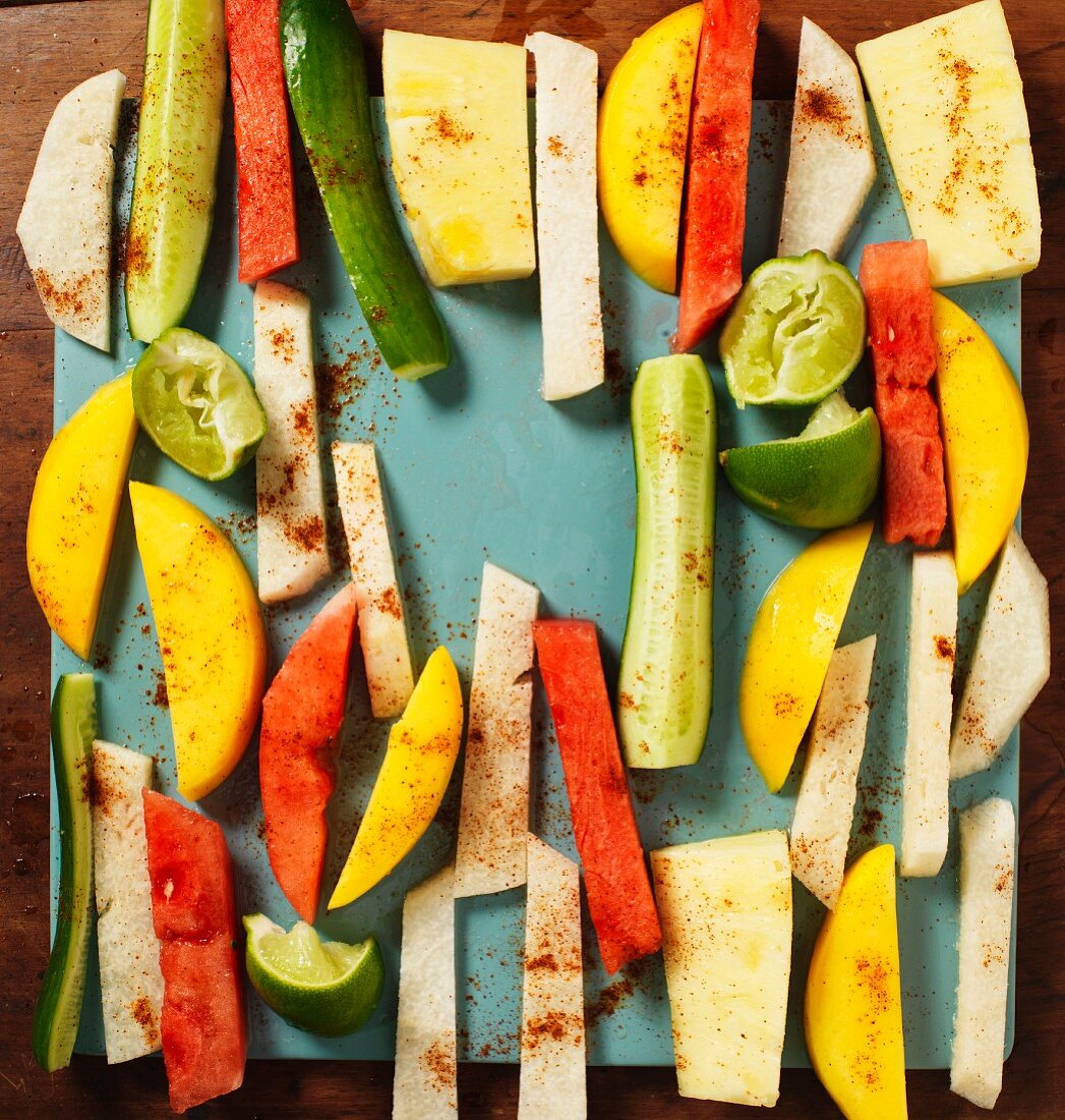 Jicama, vegetables and fruit cut into strips with lines and spices