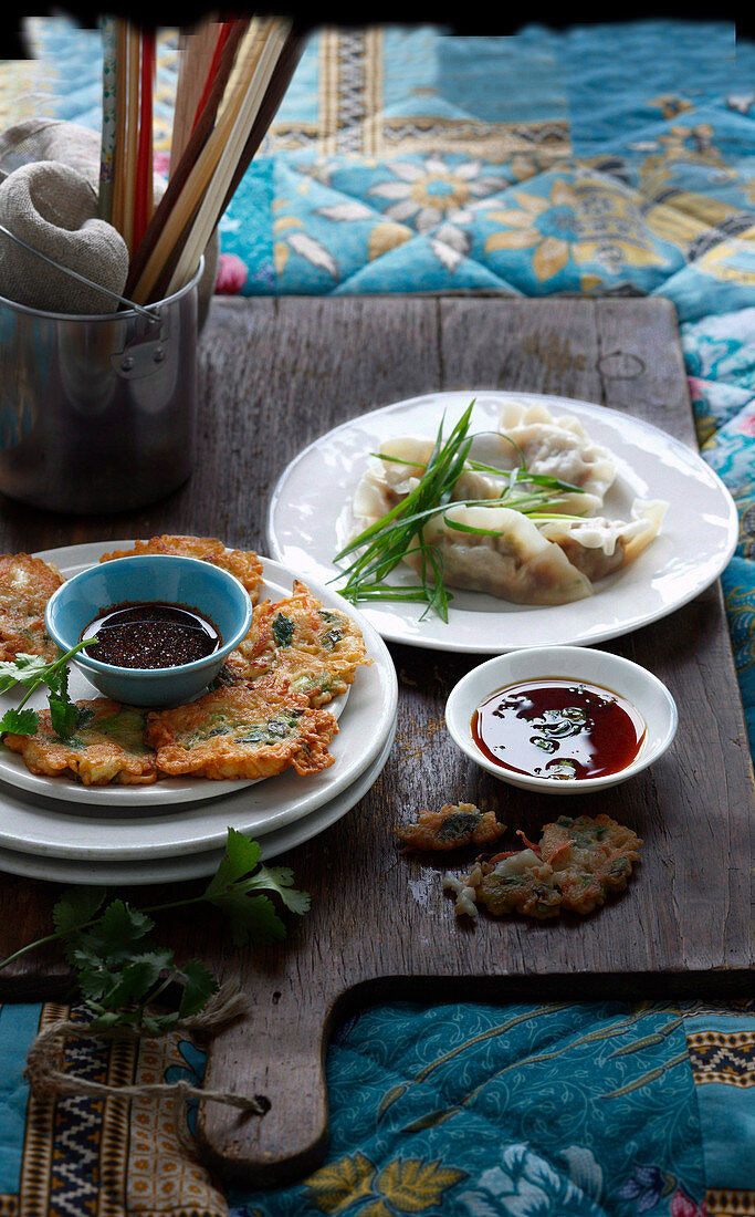 Korean appetisers, mandu (dumplings) and pajeon (stuffed pancakes) with dips