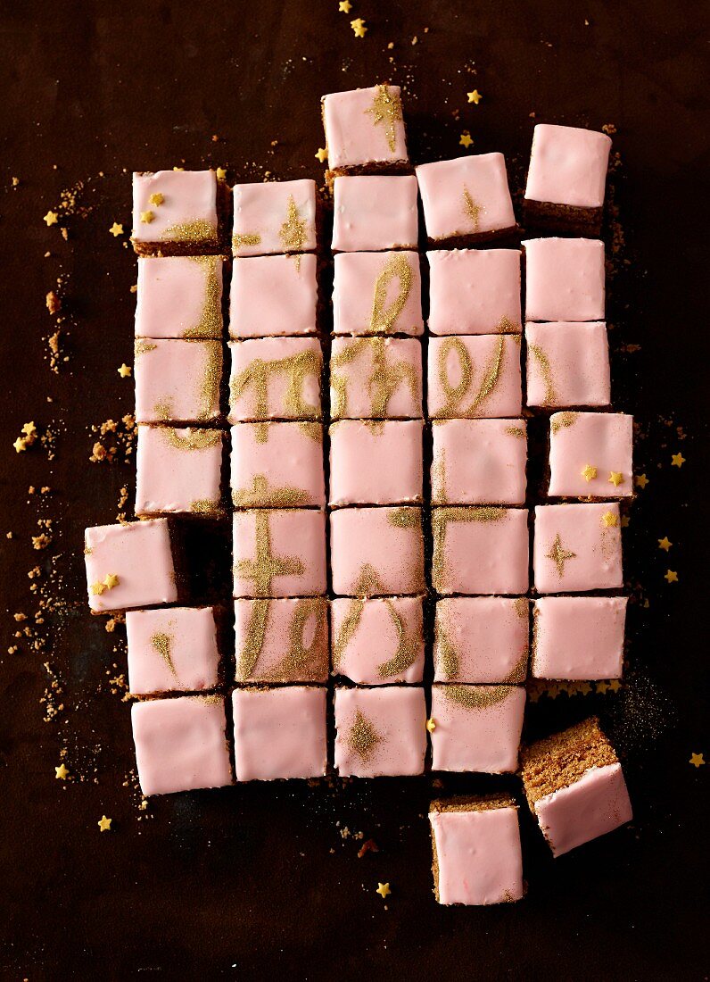 Gingerbread squares with pink icing and golden lettering