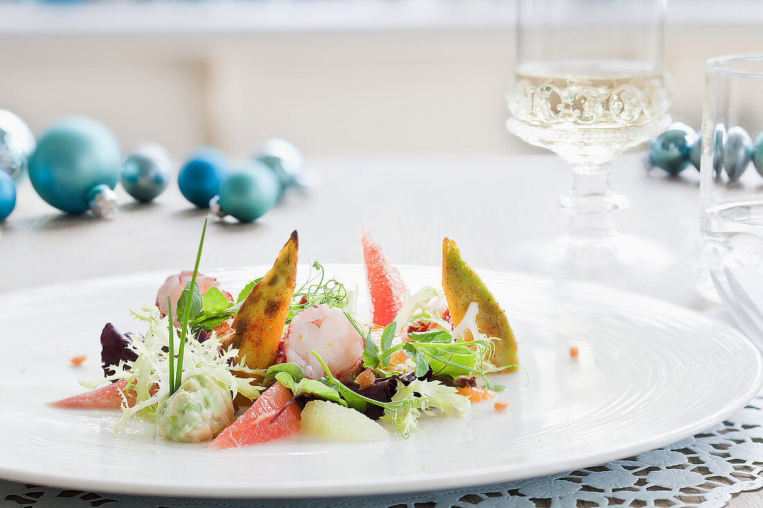 Lobster with grapefruit, avocado and a salad garnish for Christmas