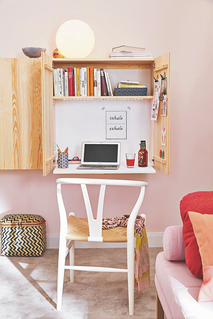 A mini office space contained in a wall cupboard