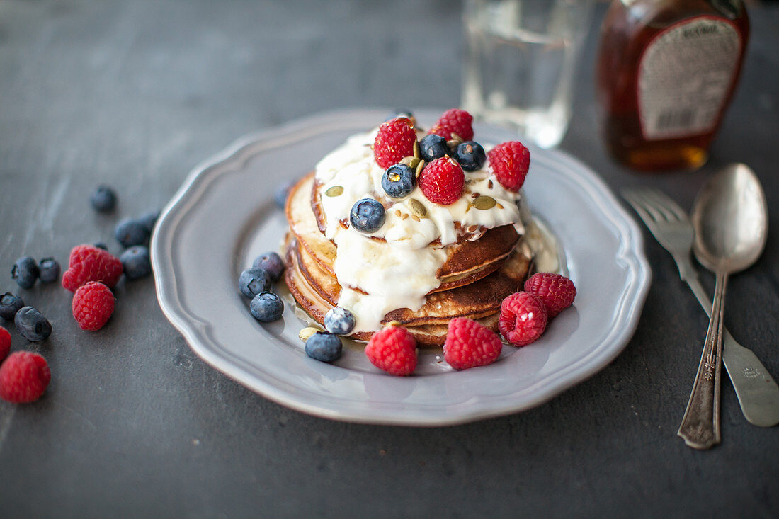Gluten-free banana pancakes with raspberries and blueberries (vegan)