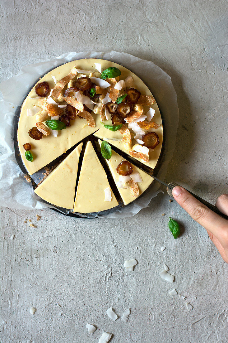 A raw lemon and basil tart with slices cut out