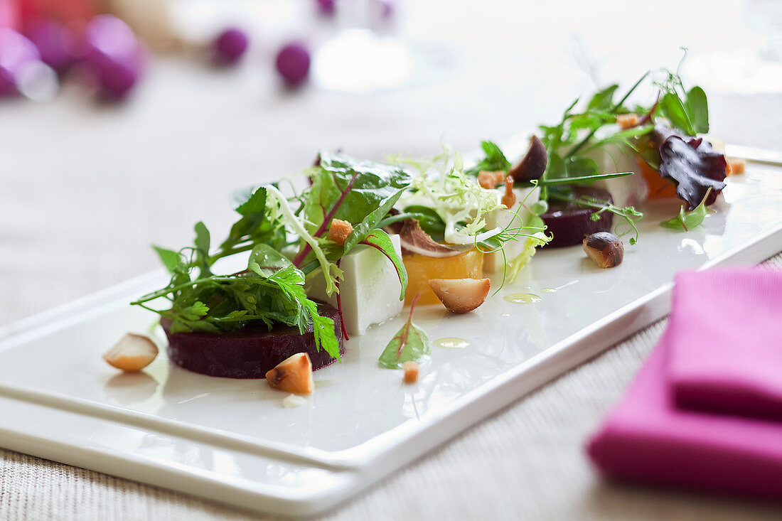 Beetroot and golden beets with sheep's cheese and a salad garnish for Christmas