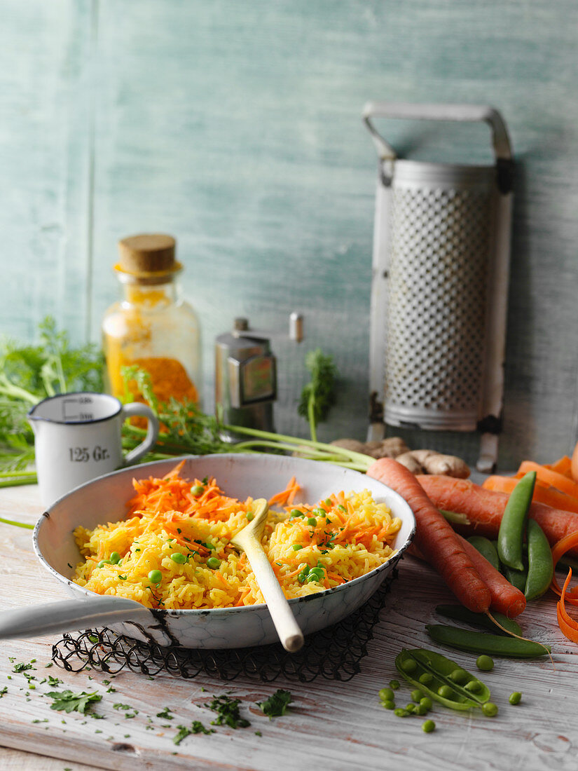 Fried turmeric rice with peas and carrot