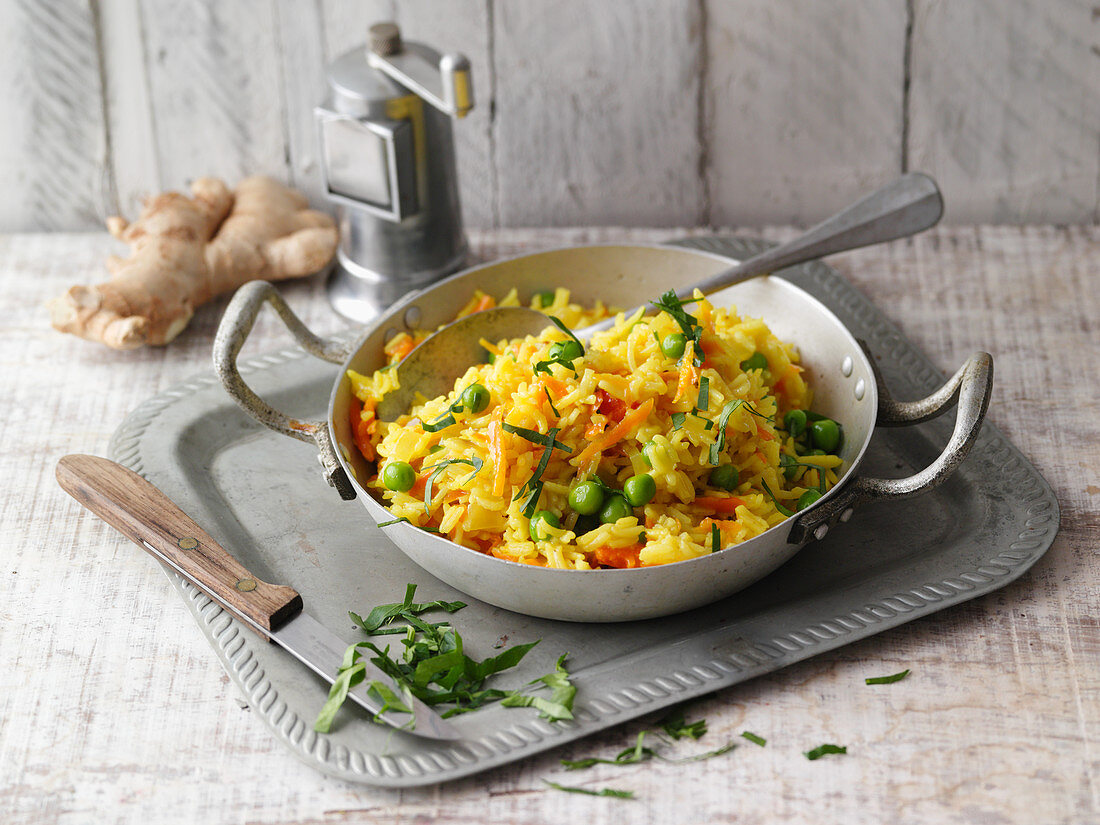 Fried turmeric rice with peas and carrot