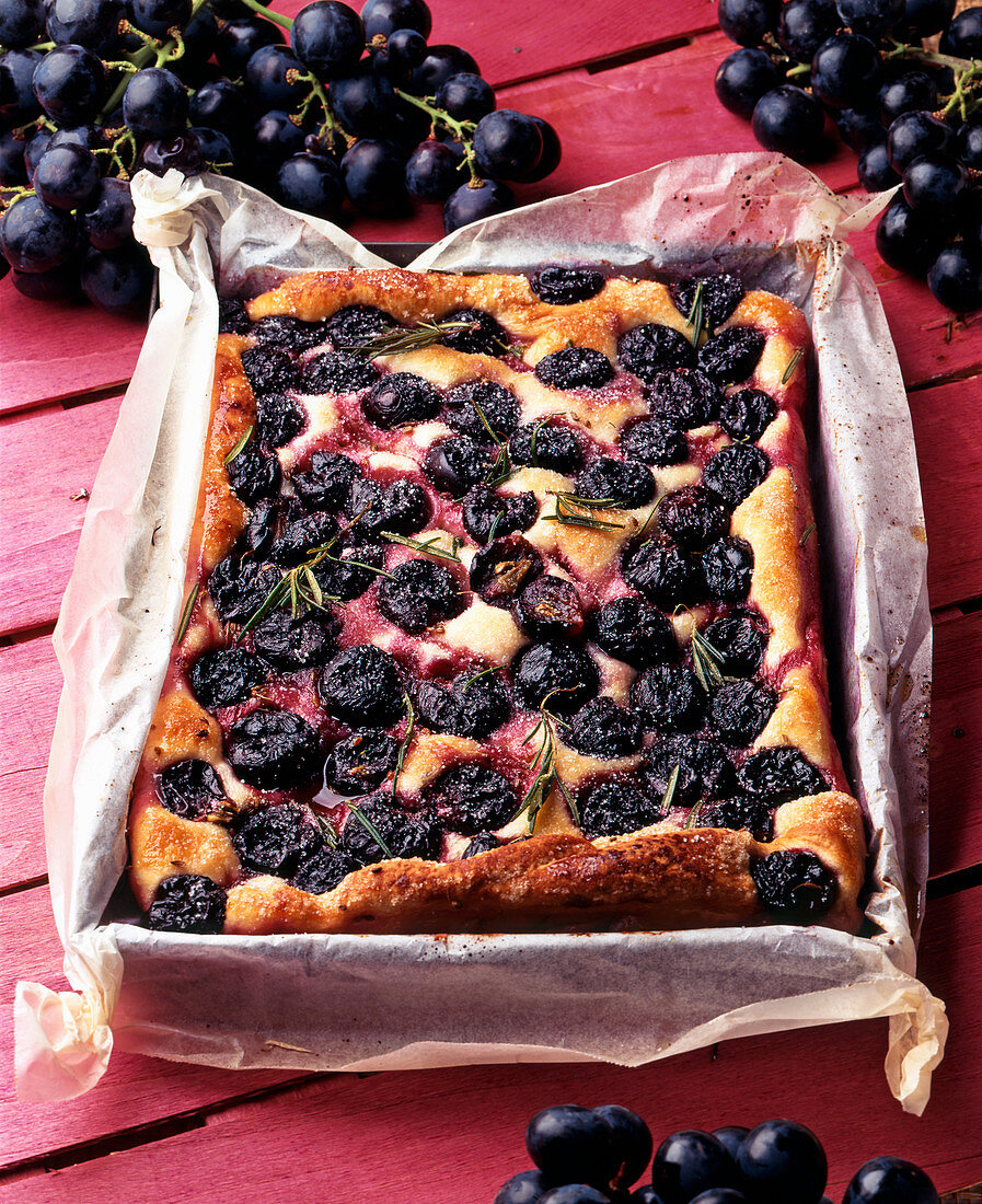 A tray bake with grapes and rosemary