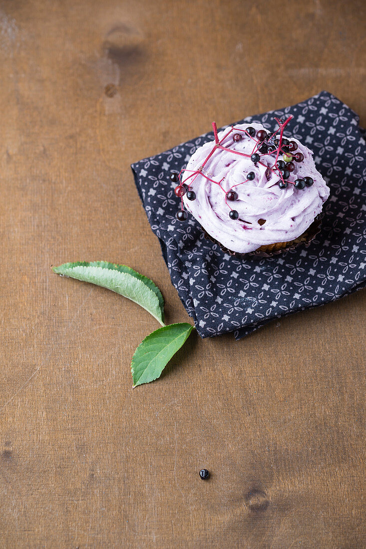 A cupcake with elderberry frosting