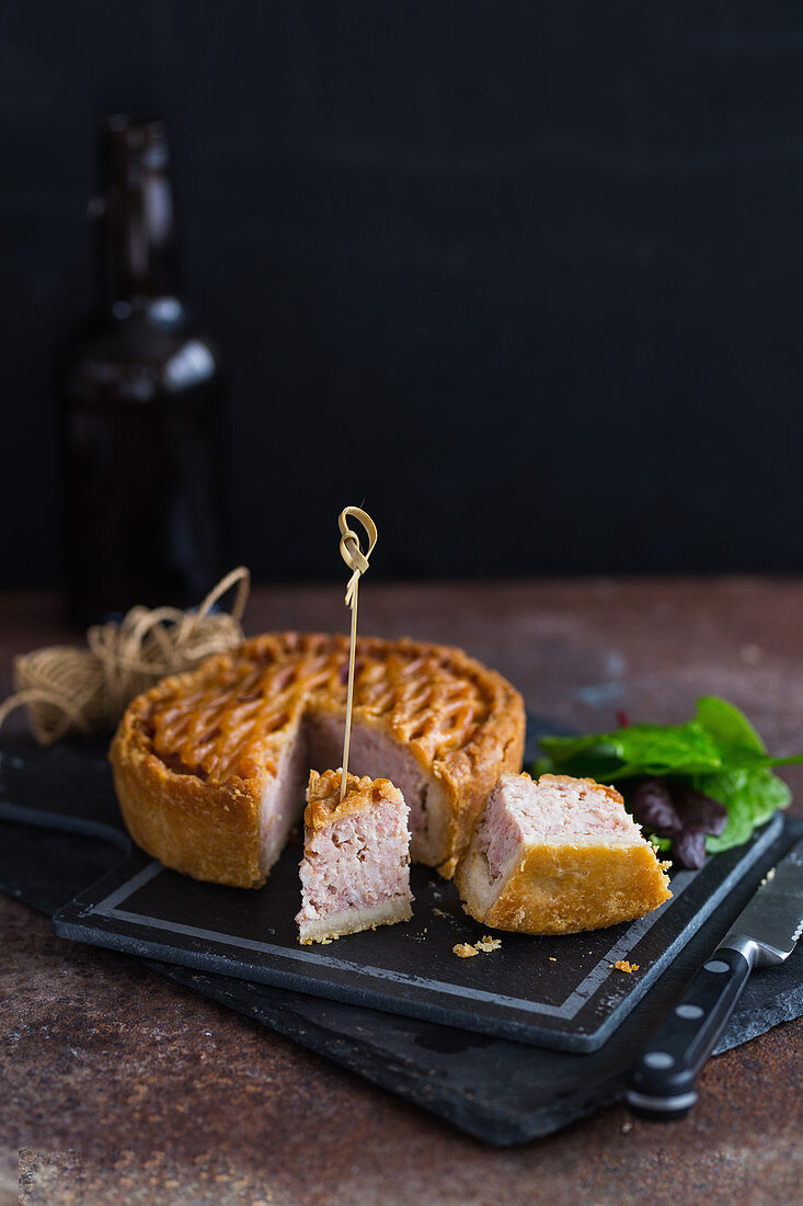 A lattice pork pie with two pieces cut out