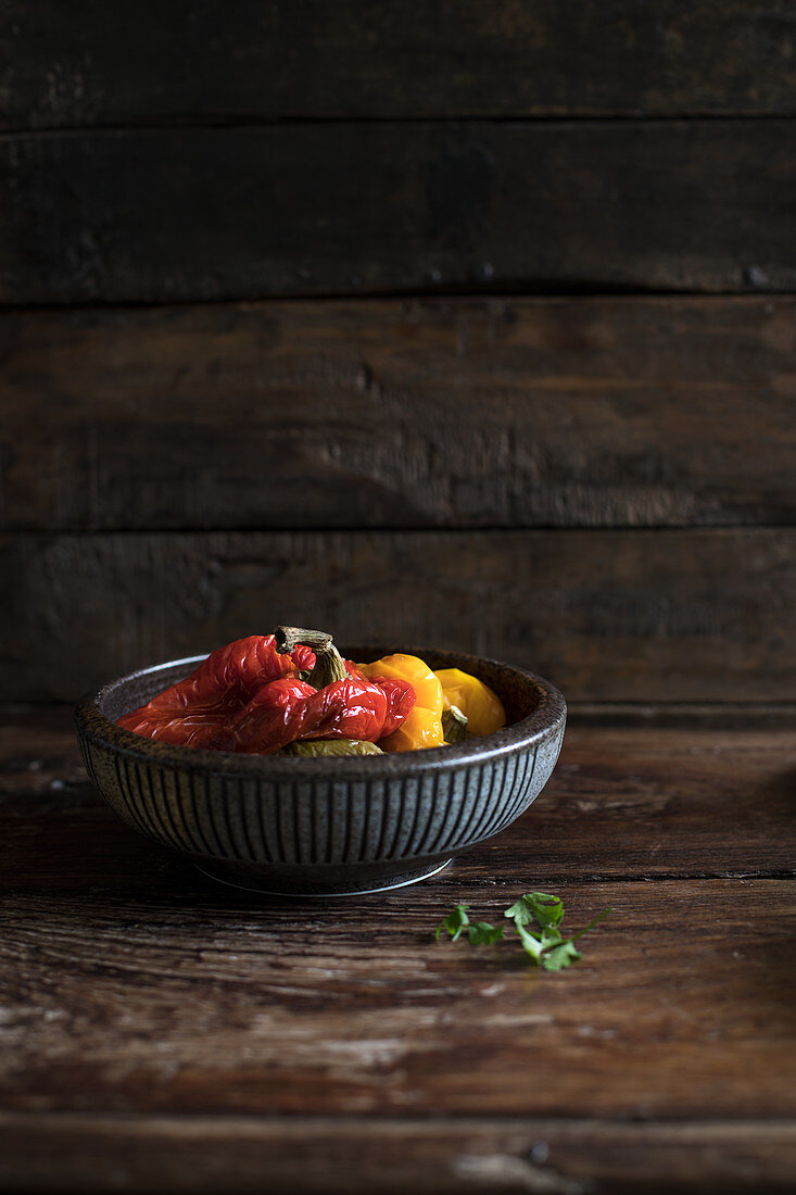 Oven-roasted pepper in a bowl against a wooden background