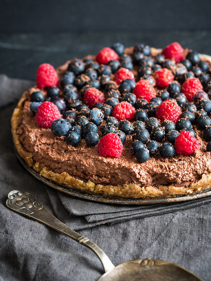 Raw vegan gluten-free chocolate tart with berries