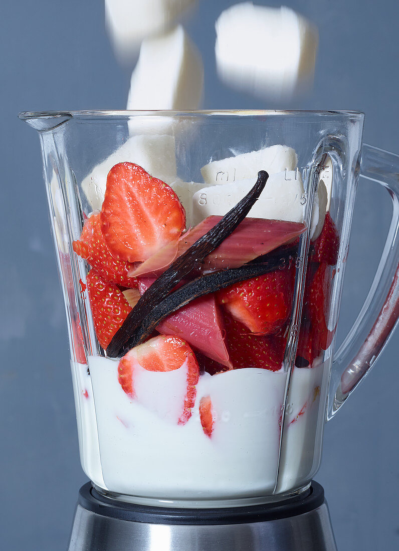Ingredients for strawberry and rhubarb frozen yoghurt in a blender