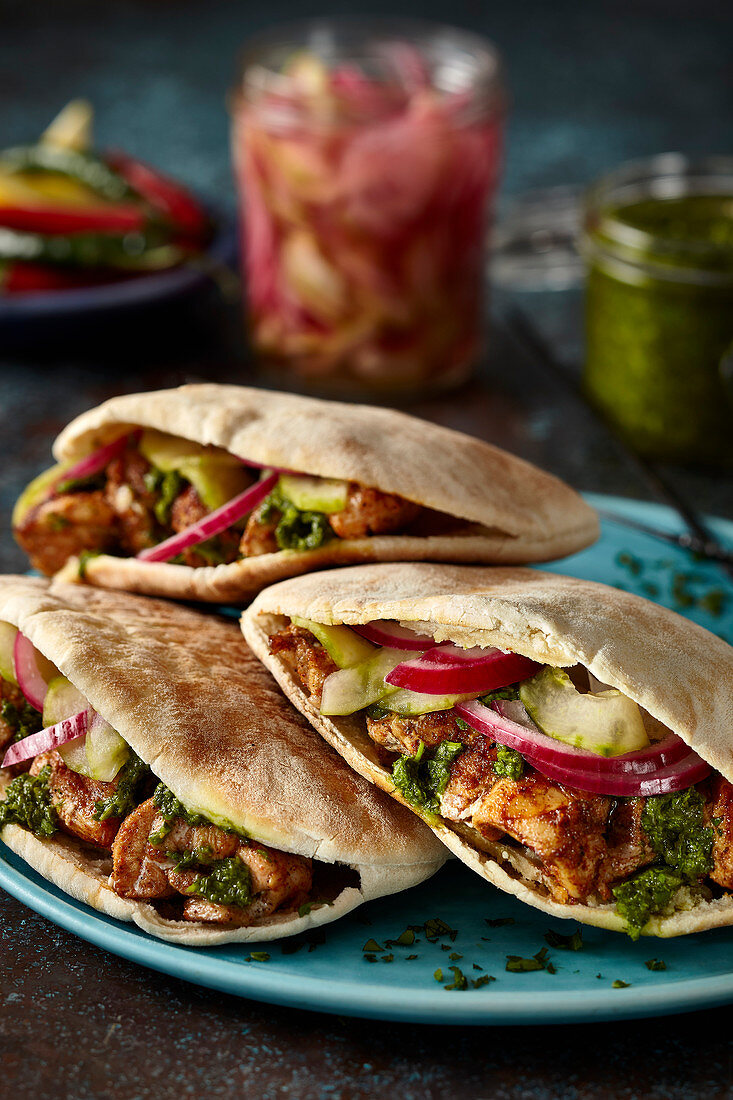 Pitta bread stuffed with chicken, cucumber and pickled red onion