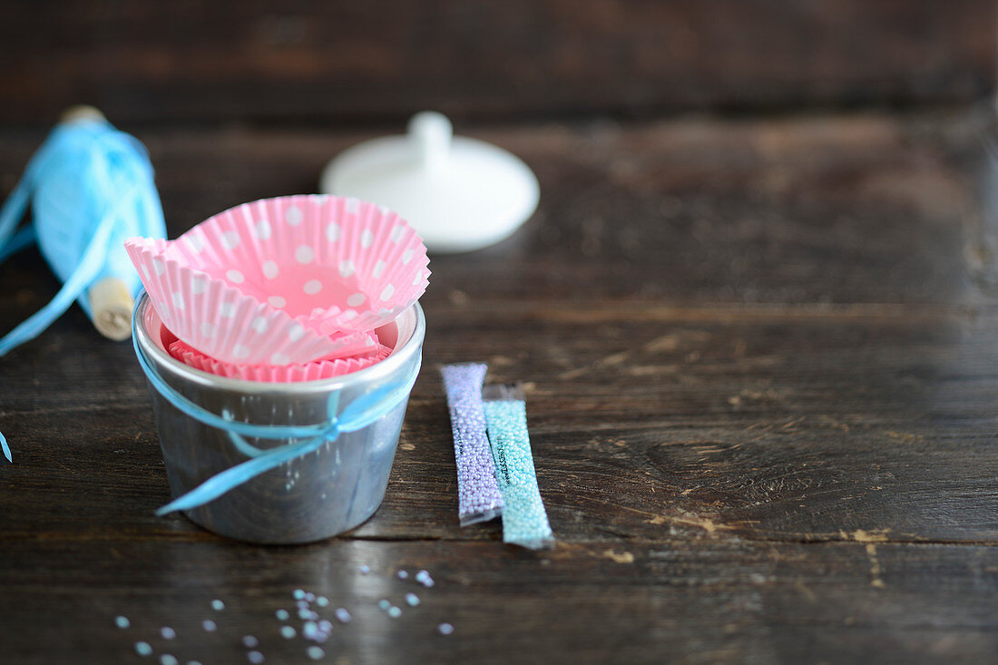 Eisbehälter, Papierförmchen und Zuckerperlen