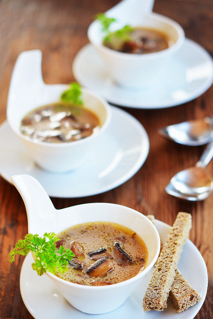 Mushroom soup with toast and fresh parsley