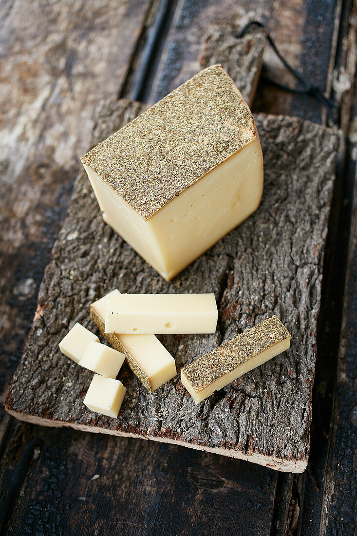 Cheese with a wild flower rind on a wooden chopping board