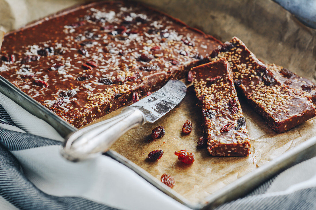 Homemade chocolate bars with raisins, sesame seeds and coconut flakes