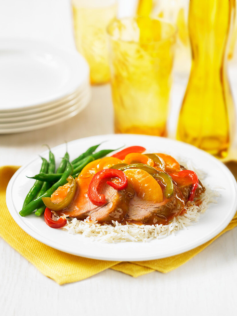 Pork with peaches, peppers, green beans and rice