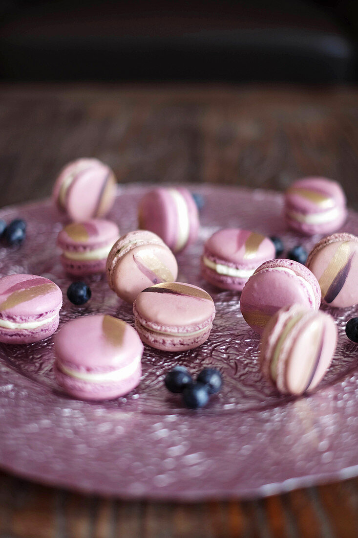 Blueberry macaroons decorated with gold