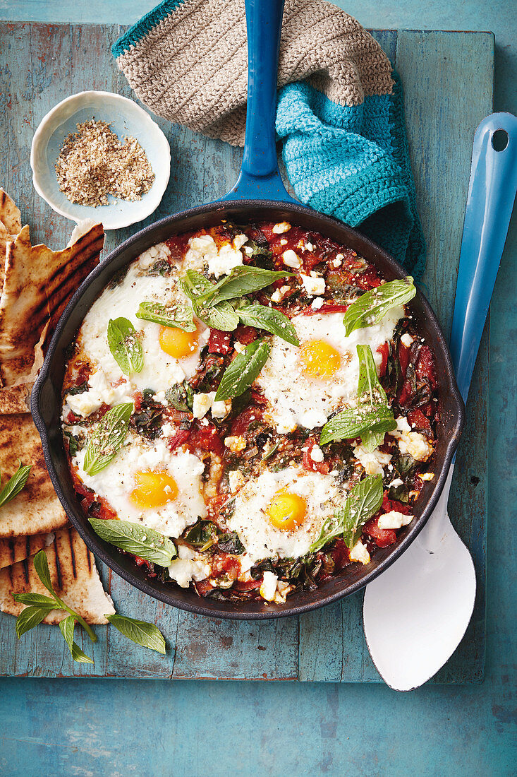 Fried eggs with chard, tomatoes and dukkah