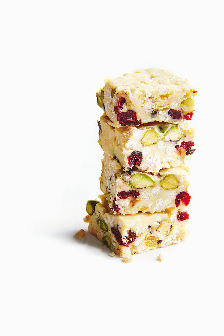 White chocolate and passion fruit bars with puffed rice, cranberries, and pistachios