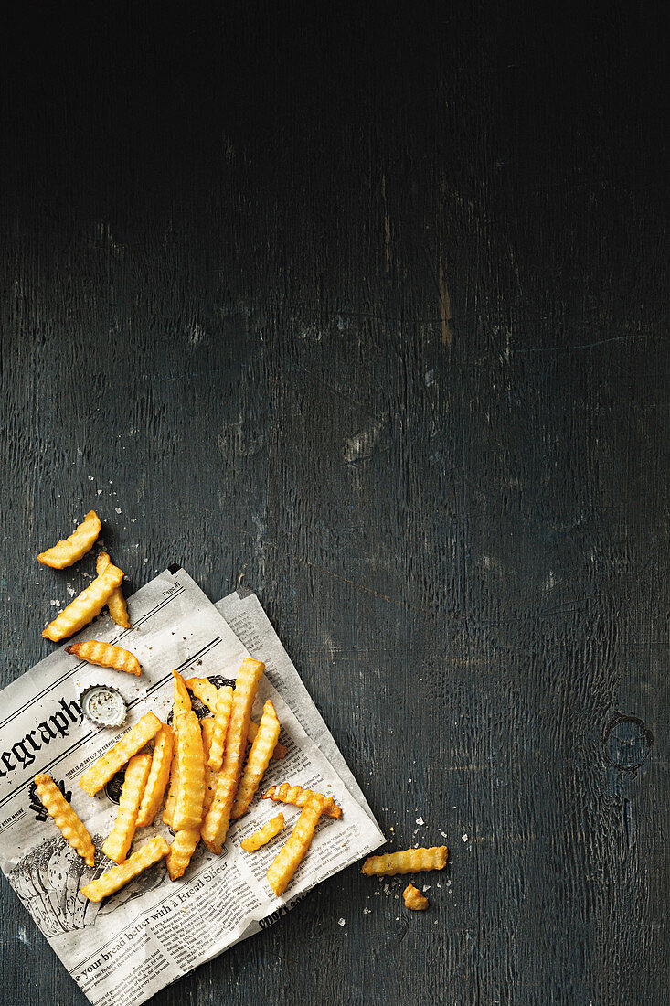 French fries on a sheet of newspaper